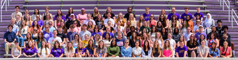 Class of 2024 poses in the stadium stands in the week before graduation