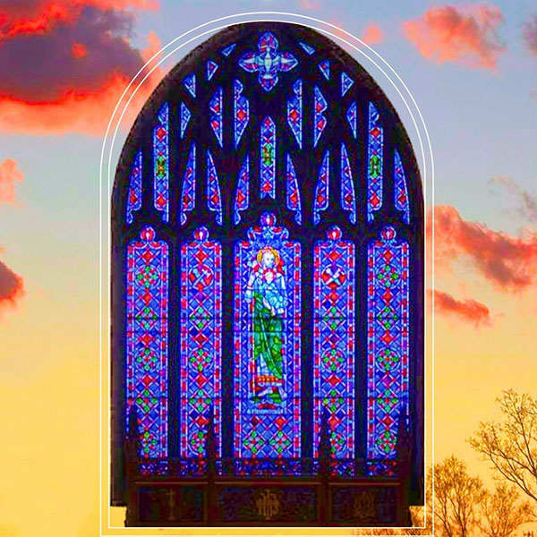 stained glass window on backdrop of sky at sunset
