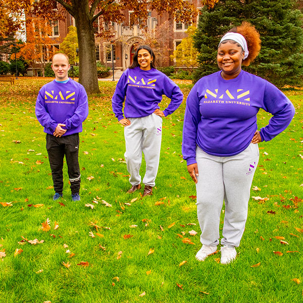 three students wearing NAZ sweatshirts