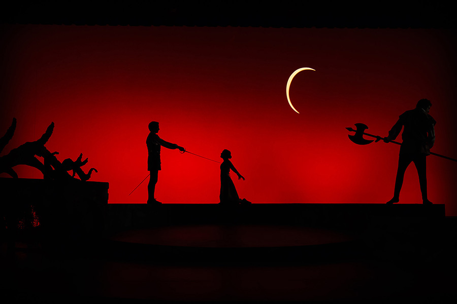 actors in silhouette performing on stage