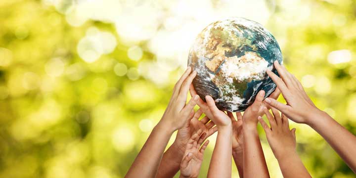 hands holding up globe of Earth