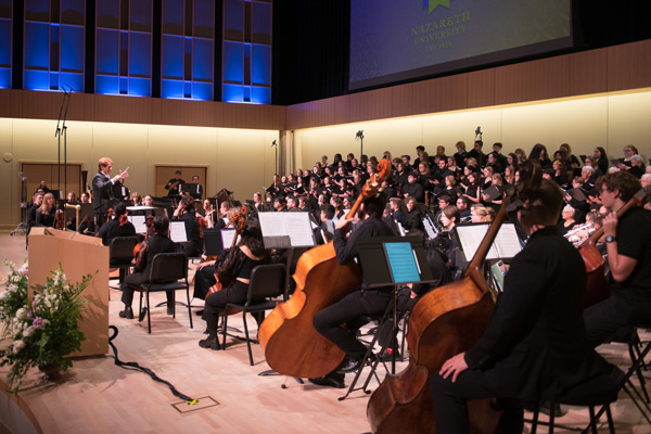 Jack Allocco conducts dozens of musicians performing the piece he composed 