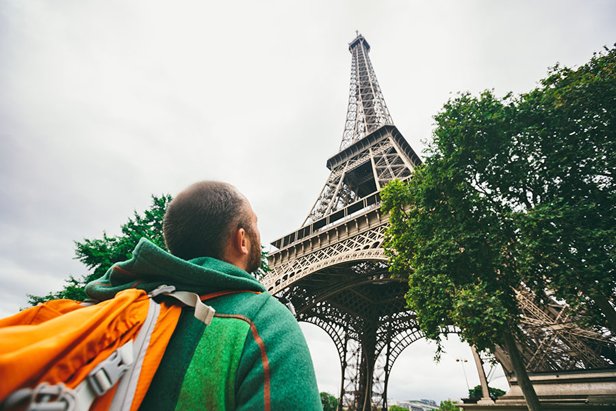 student looking up at the Eiffel Tower