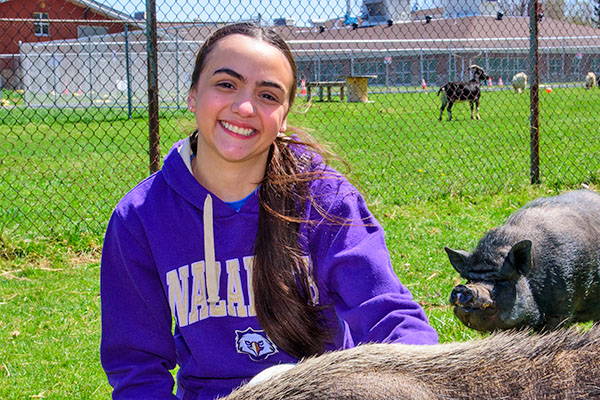 Sophia Duran with pigs at animal shelter