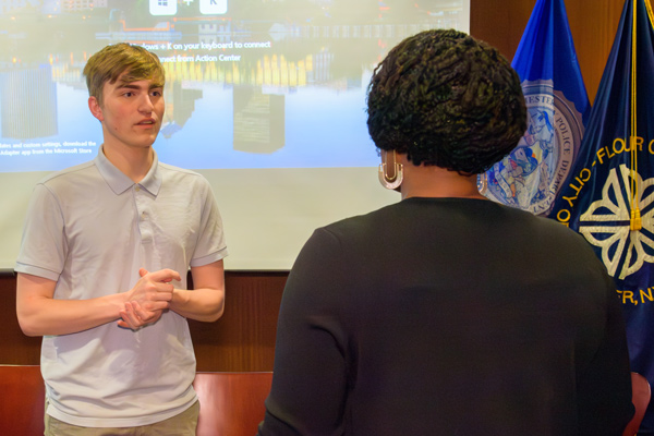 Jacob Koles talks with Leadership Rochester's leader during community engagement work