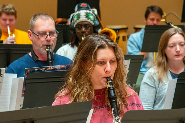 Playing brass and woodwinds are musicians of varying ages — students, alumni, and local residents.