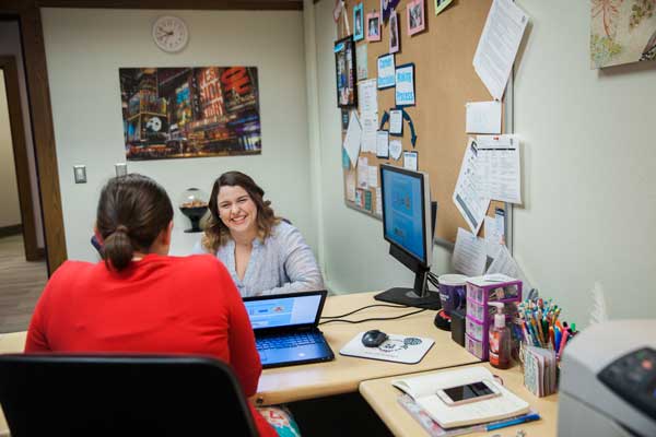 career services career coach and student meet in office