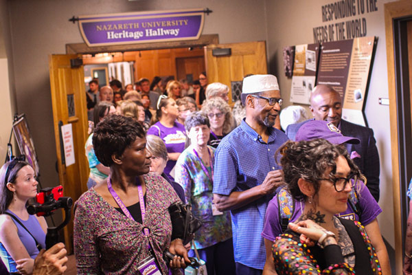 People pack the new Heritage Hallway in Golisano Academic Center to view the history wall opening 