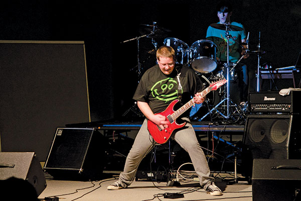 musician on stage playing electric guitar