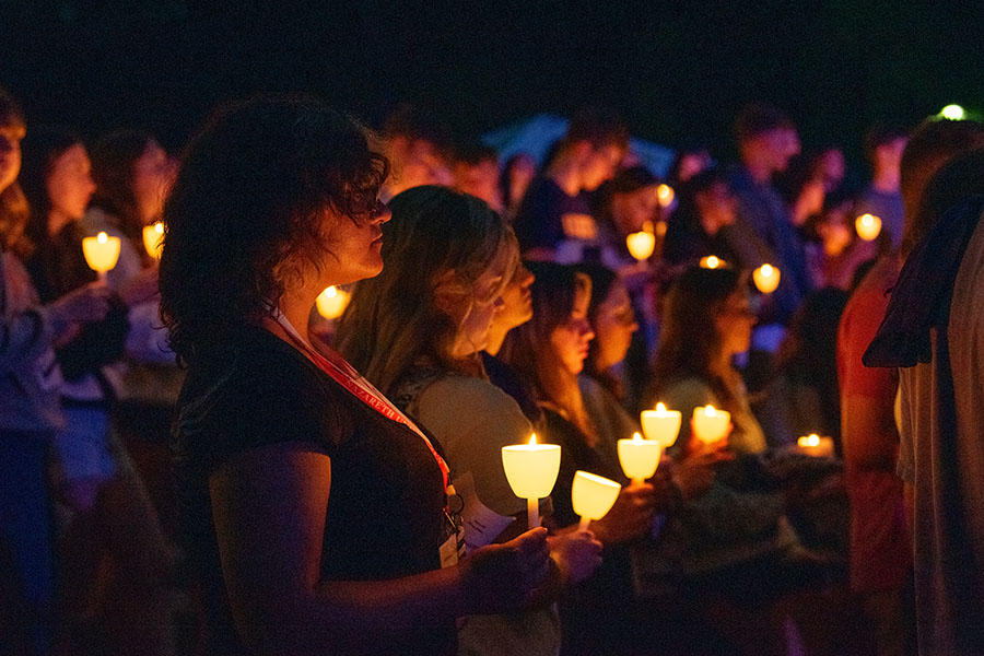 students holding candles during a vigil