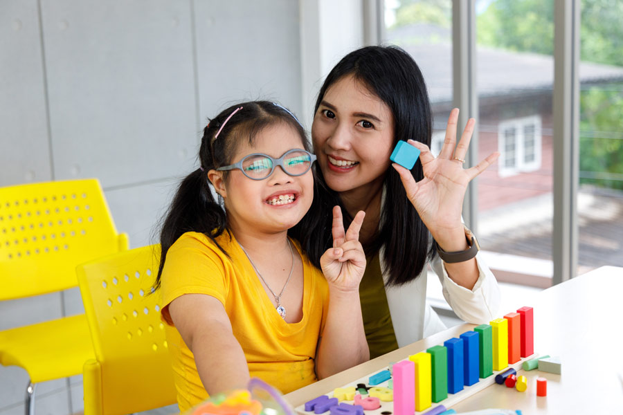 girl and woman smile by colorful toys