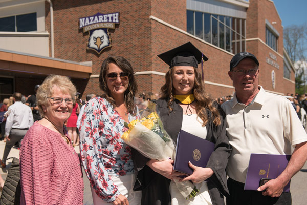 A family poses outside Golisano Training Center at Commencement 2022. 