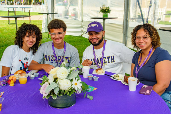 A family poses at a table at the Parent & Family Breakfast