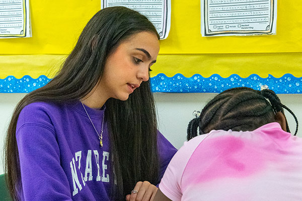 Sophia Duran working with young student