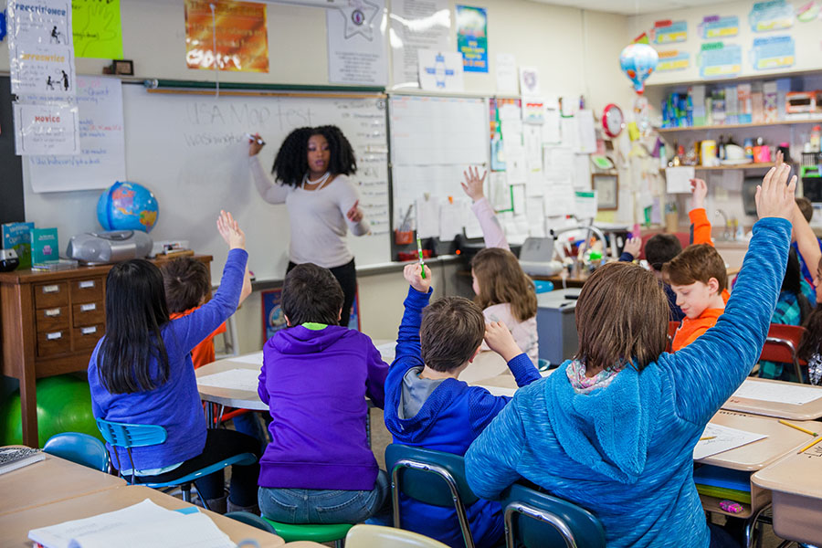 teaching calling on young children with their hands raised