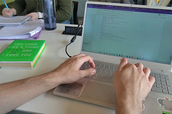 a student coding on a laptop