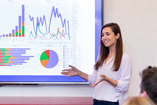 student presenting a slide with financial data