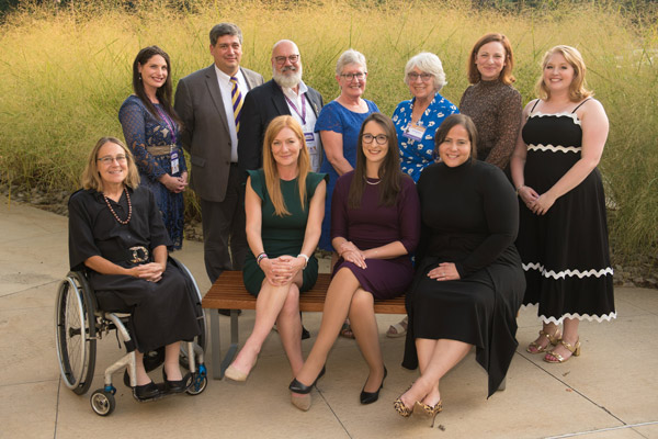 Alumni award recipients pose for a group photo outside