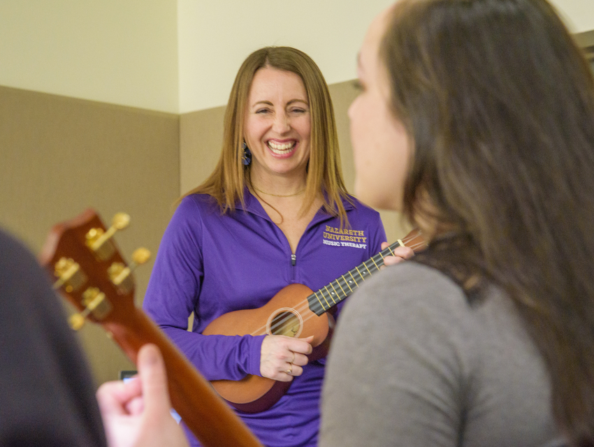 Women playing ukulele