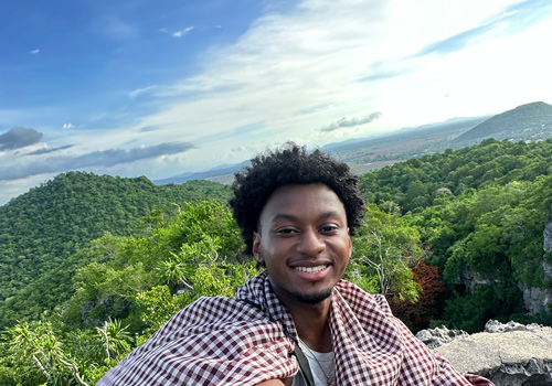 Denim Powers, HEOP student, hiking up Phnom Sampeau Mountain, Cambodia, during Nazareth study abroad