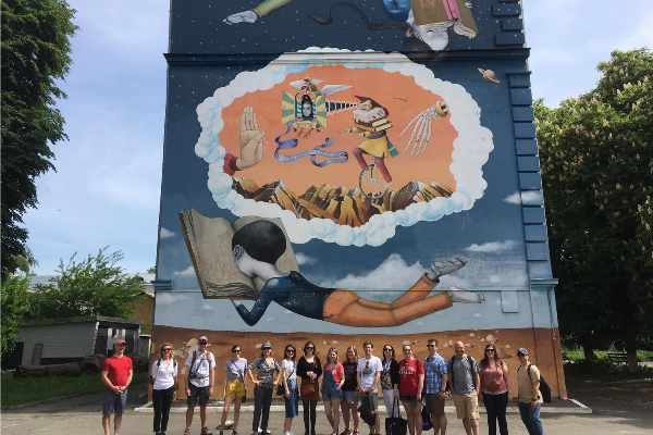 A Nazareth group photo by a mural on the campus of the National University of Kyiv-Mohyla Academy