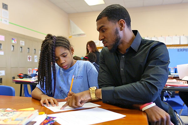 student teacher instructing middleschooler