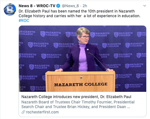 Beth Paul stands at podium at Nazareth College.