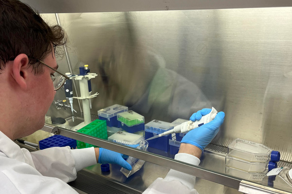 student using a pipette in a laboratory