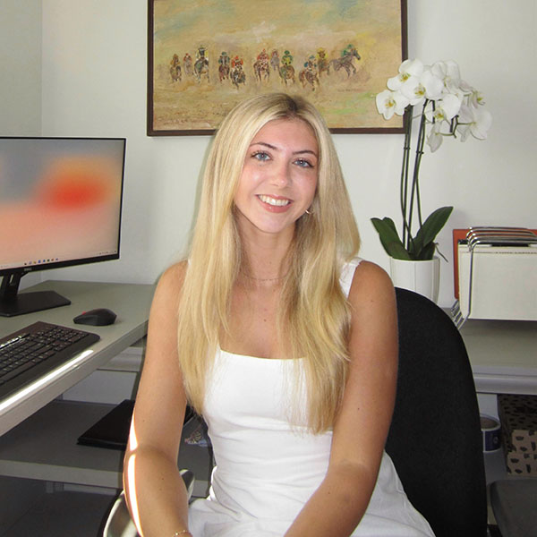 Grace Stolberg seated at a home office desk