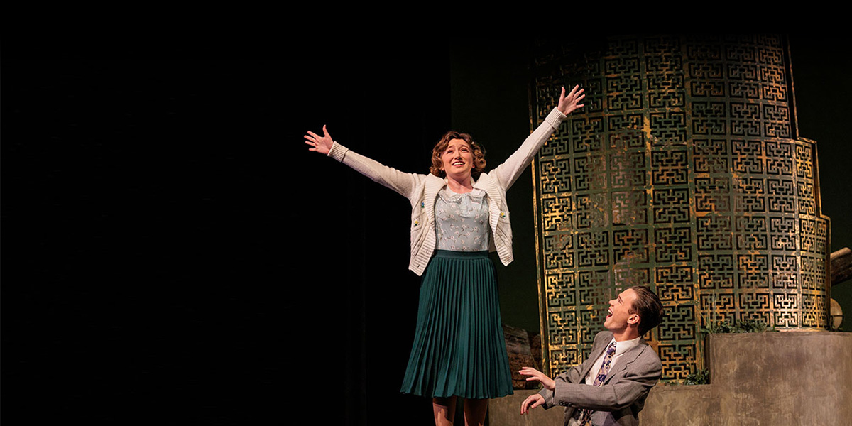 two student actors on stage performing