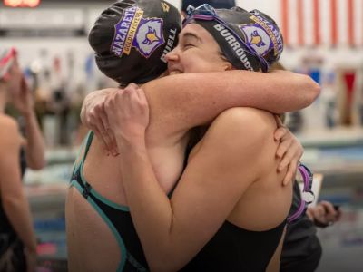Two swimmers hug after race