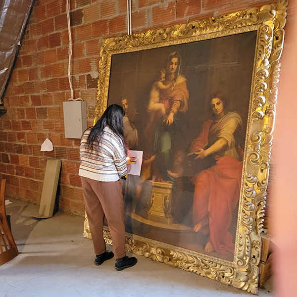 Addison Wallace scanning a mysterious painting in the library attic