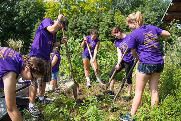 students raking leaves