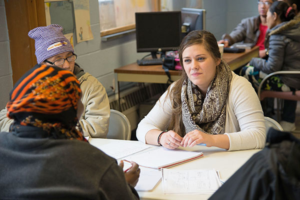 student meeting clients at refugee center