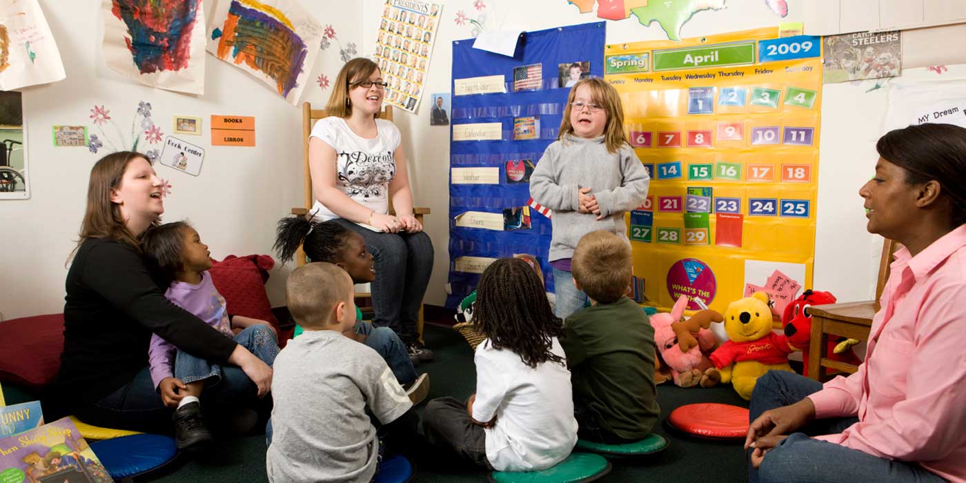 child speaking to a group of peers