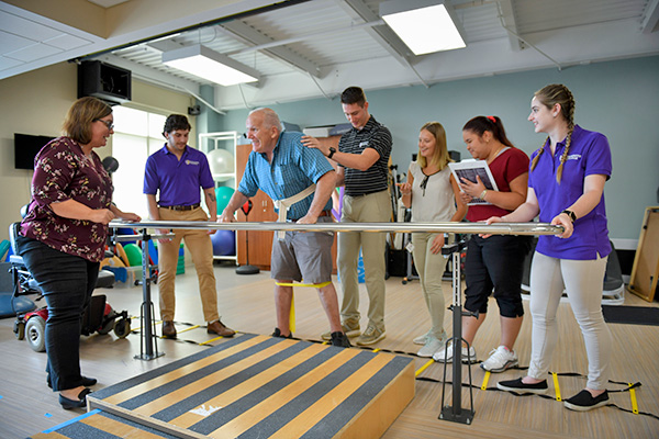 physical therapy class working with senior citizen