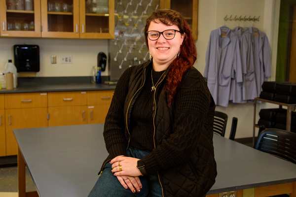 Layla Boyer poses in a clinical lab sciences lab classroom at Naz