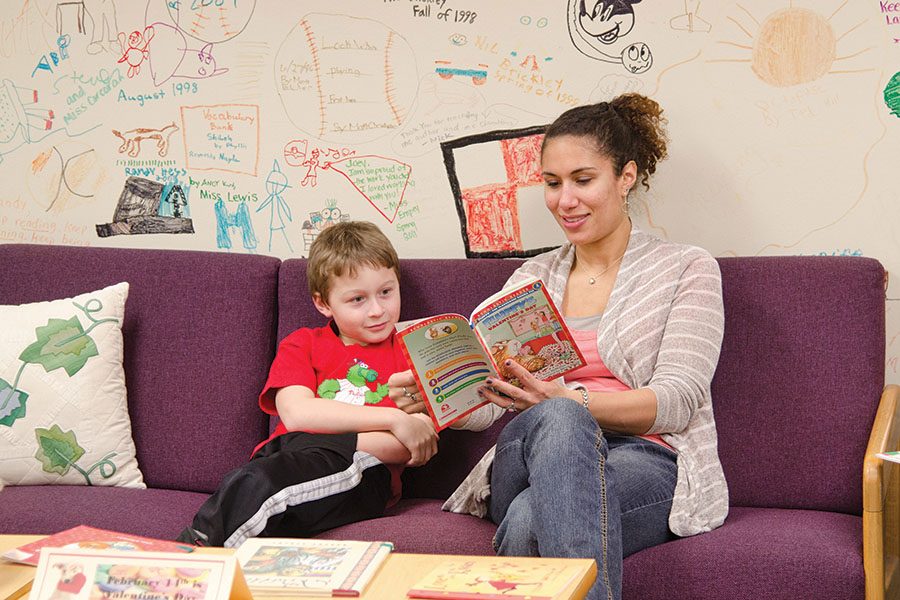 student teacher reading to young child