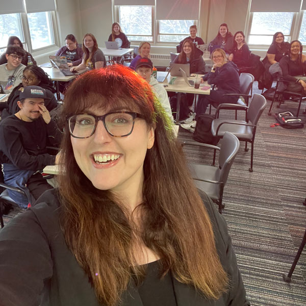 Jenn Billinson selfie with students in classroom