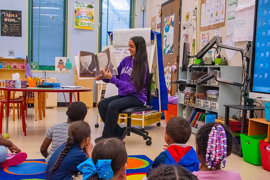 student teacher reading to class of young children