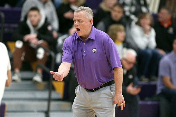 Kevin Broderick yells from the sidelines at a basketball game 