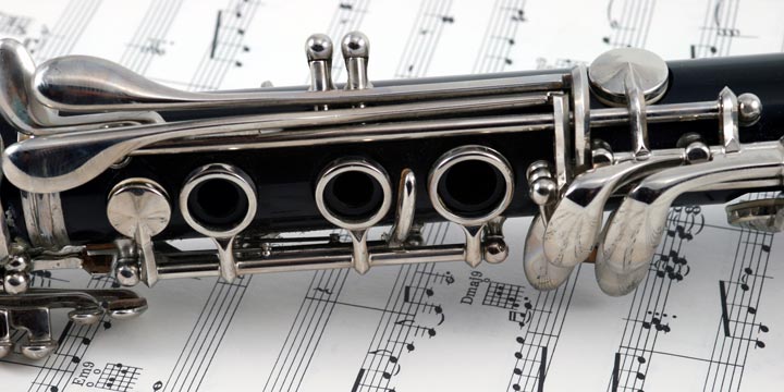 close up of clarinet on sheet music