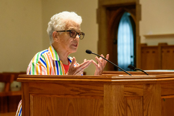 Patricia Schoelles speaks at the chapel podium, a Shannon Centennial Summit lecture