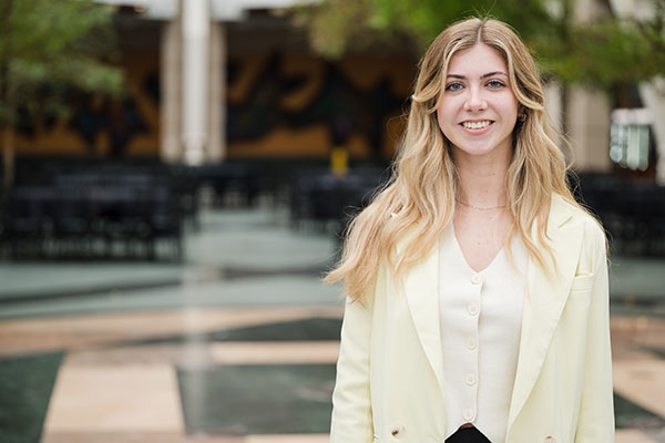 Grace Stolberg standing in a corporate atrium