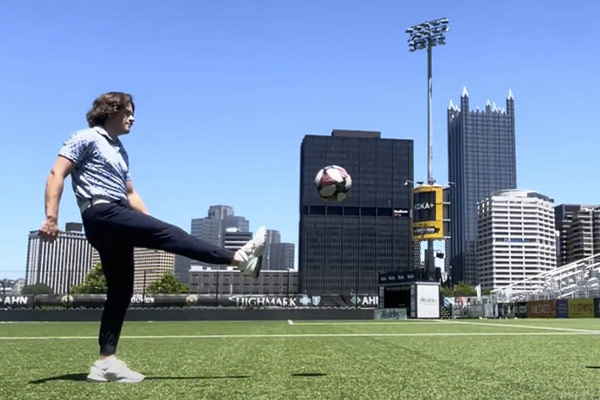 Colin Rider kicking soccer ball at internship