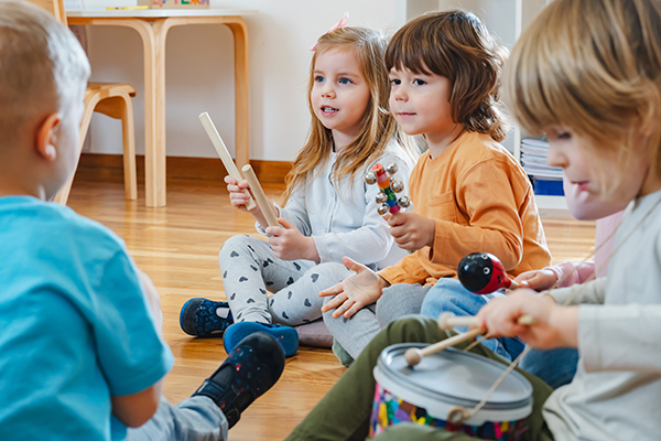 Children sitting on floor playing instruments