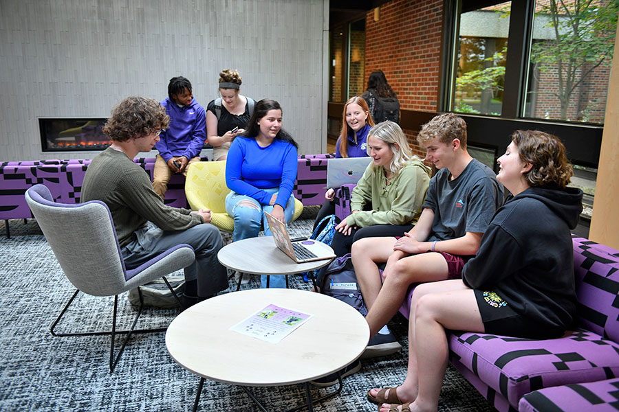 group of students conversing in dorm lounge