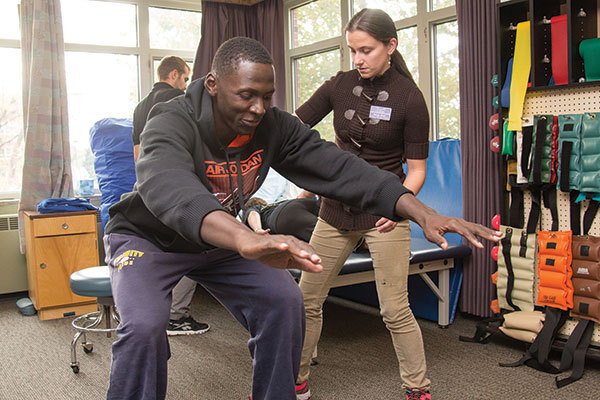 physical therapist working with an athlete