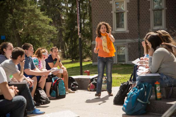 professor teaching class outdoors on front steps of Golisano Academic Center