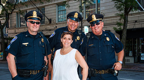 Jenna Knauf with uniformed police officers at Rochester Jazz Fest